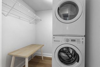 A washer and dryer in a room with a table
